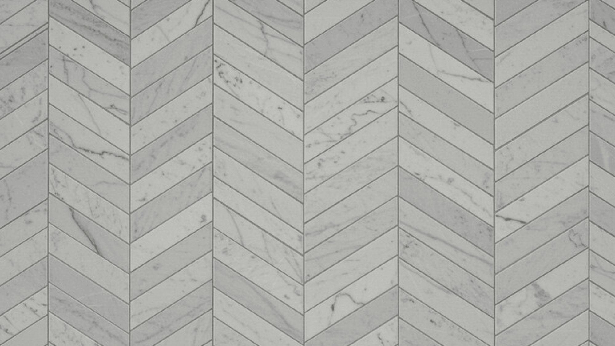 white marble tiles in a chevron pattern with grey veining