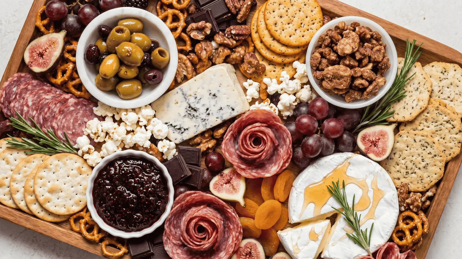 A balanced board with fruits, cheese, nuts, and snacks combining sweet and savory flavors in clear sections.