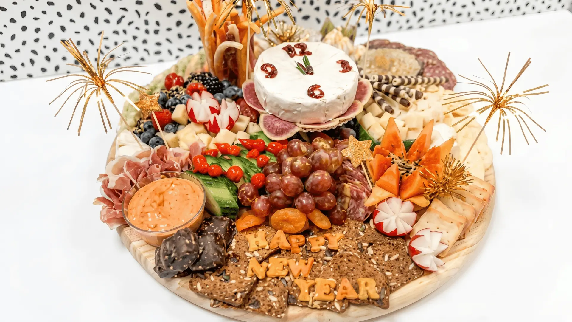 A clean and simple party board with a mix of sweet and savory snacks, arranged for quick access during celebrations.