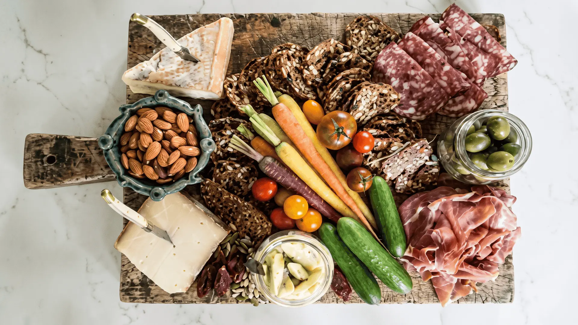 A complete meal board with protein, carbs, and sides arranged in sections for a well-rounded setup.