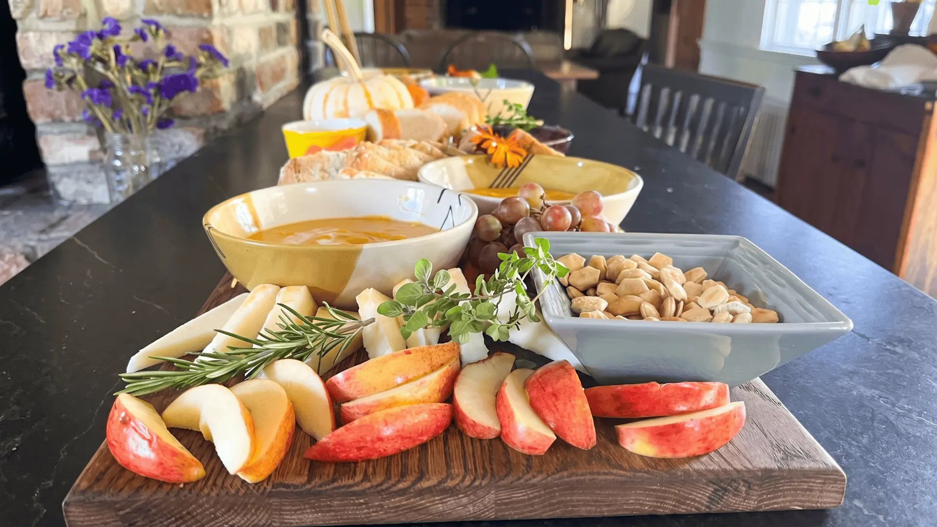 A cozy snack board with warm fried bites, chutneys, and dips, arranged for easy indoor serving on a rainy day.