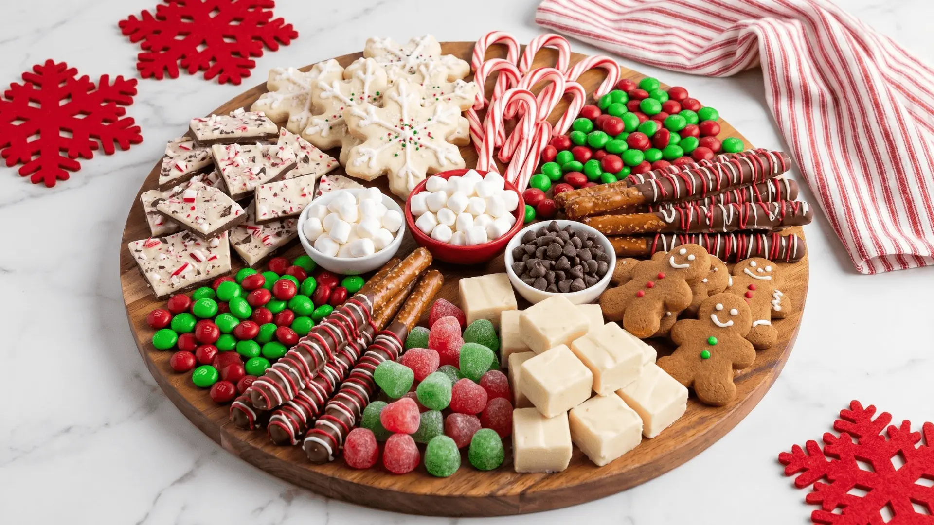 A dessert board with chocolates, cookies, and bite-sized treats, paired with a simple dip for easy sharing.