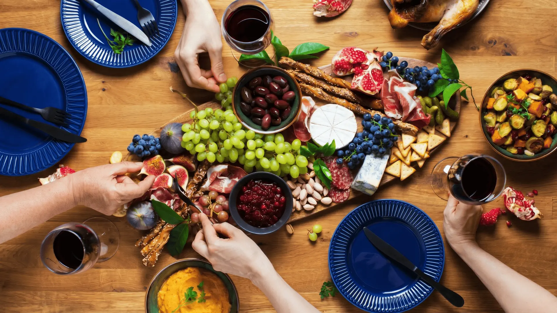 A wrap board with flatbreads, vegetables, proteins, spreads, and sauces in small bowls, arranged in sections for making custom wraps.
