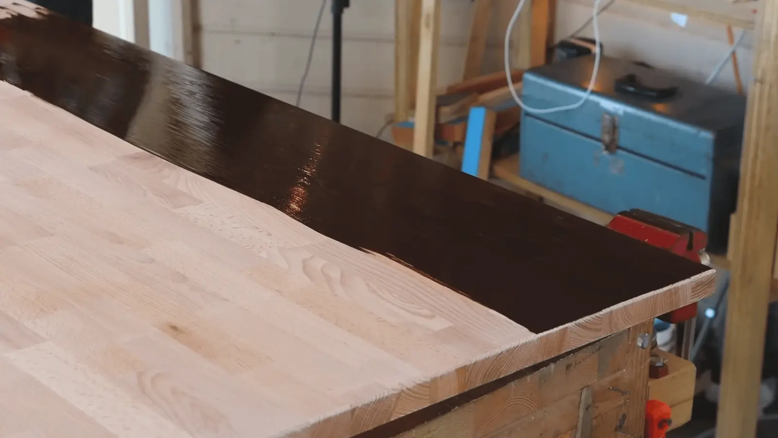 Applying wood stain with foam brush and wiping along grain