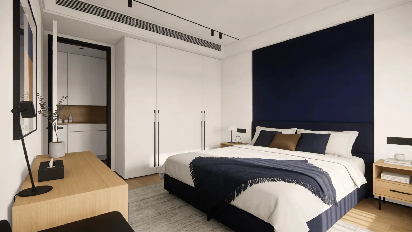 Bedroom with navy accent wall and white surrounding walls behind a bed