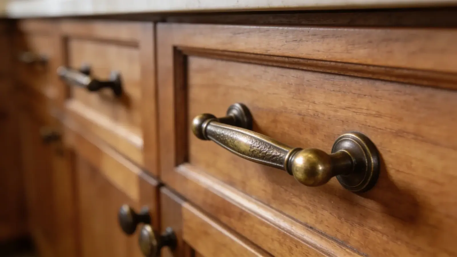 Cabinet handles in bronze or brass finish on wood cabinets