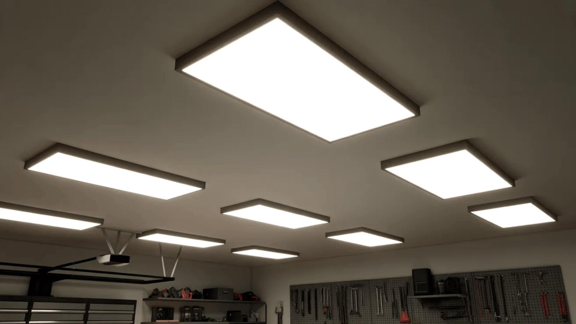 Ceiling-mounted LED lights illuminating a garage workspace