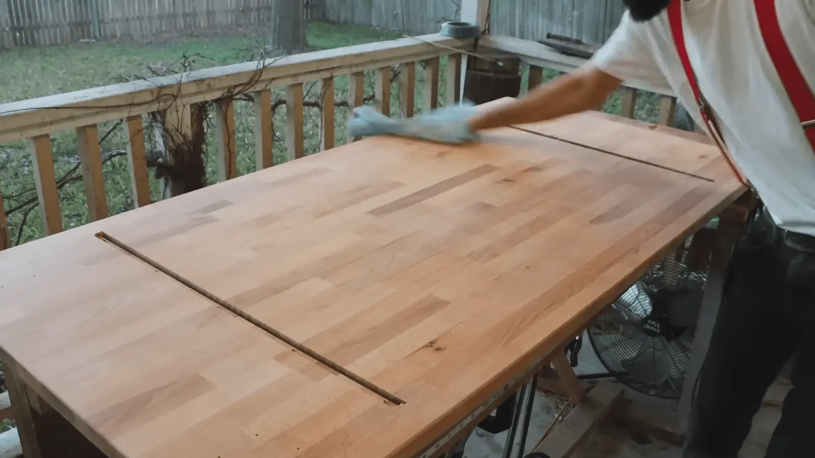 Cleaning wood surface with brush and cloth to remove dust