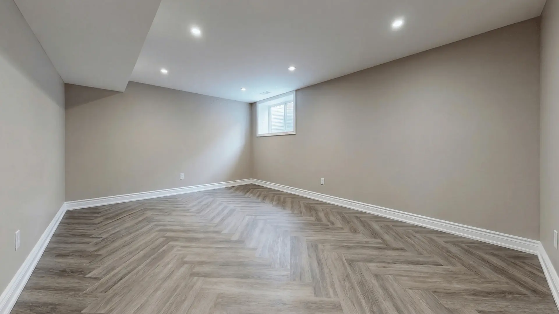 Finished basement with luxury vinyl plank flooring, neutral walls, and drywall ceiling