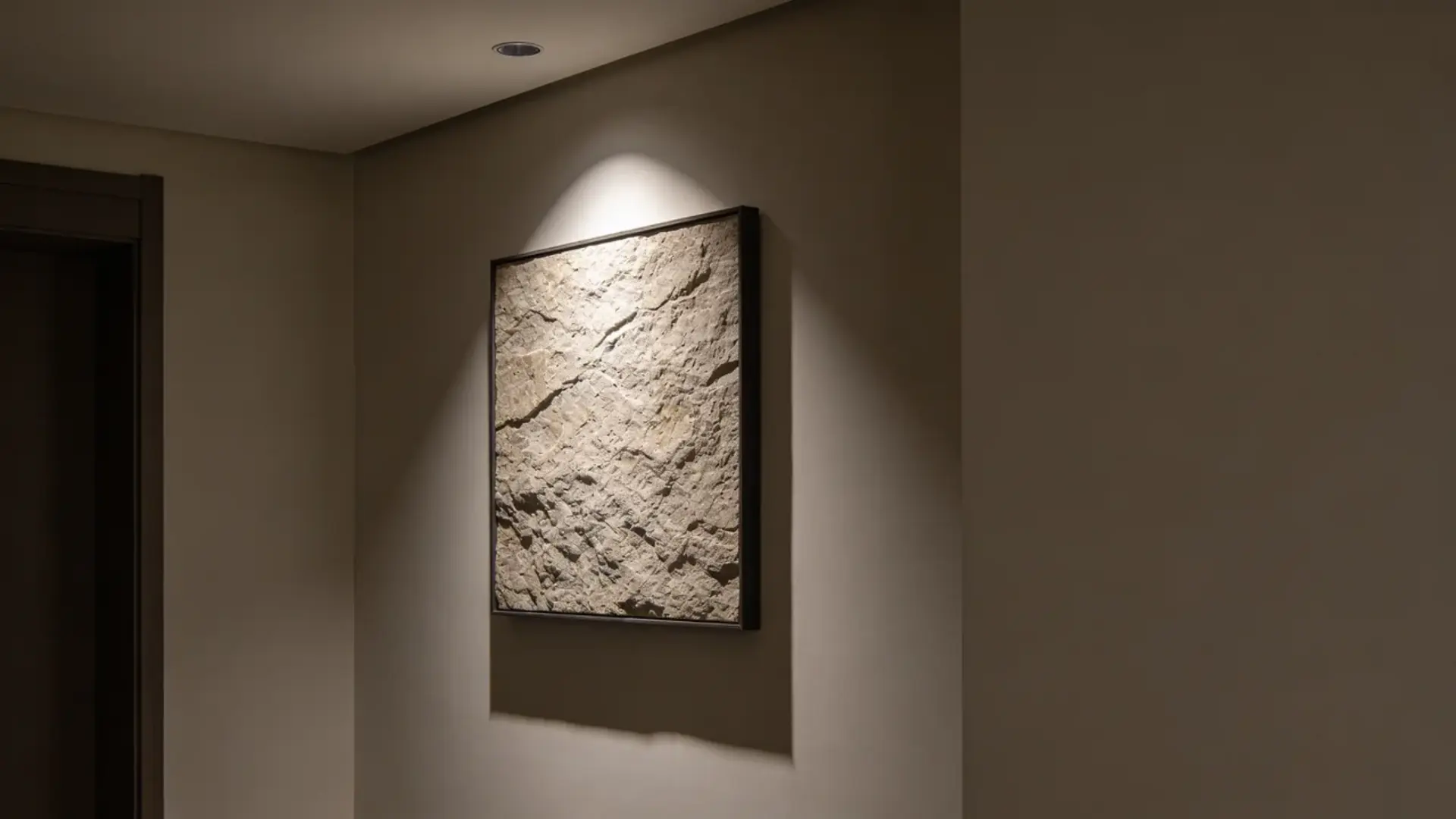 Focused light highlighting one wall feature while surrounding areas are dim