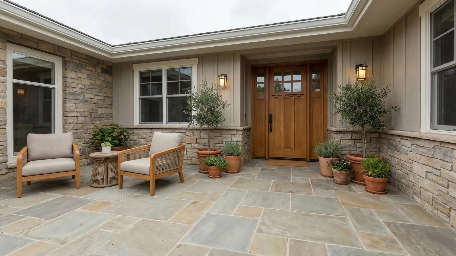 Front patio with seating, plants, lighting, and paved flooring at the house entrance