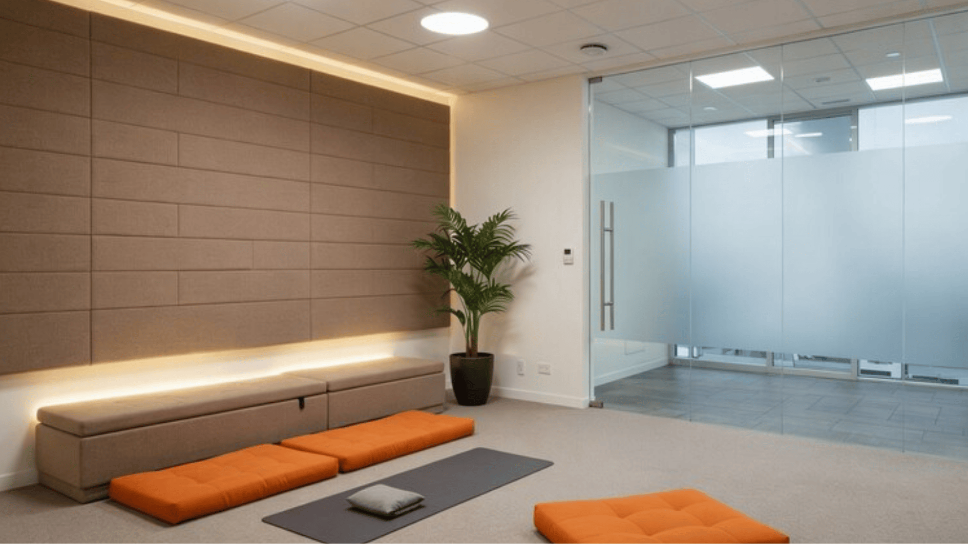 office wellness room with meditation mats, floor cushions, soft lighting, and glass partitions designed for relaxation