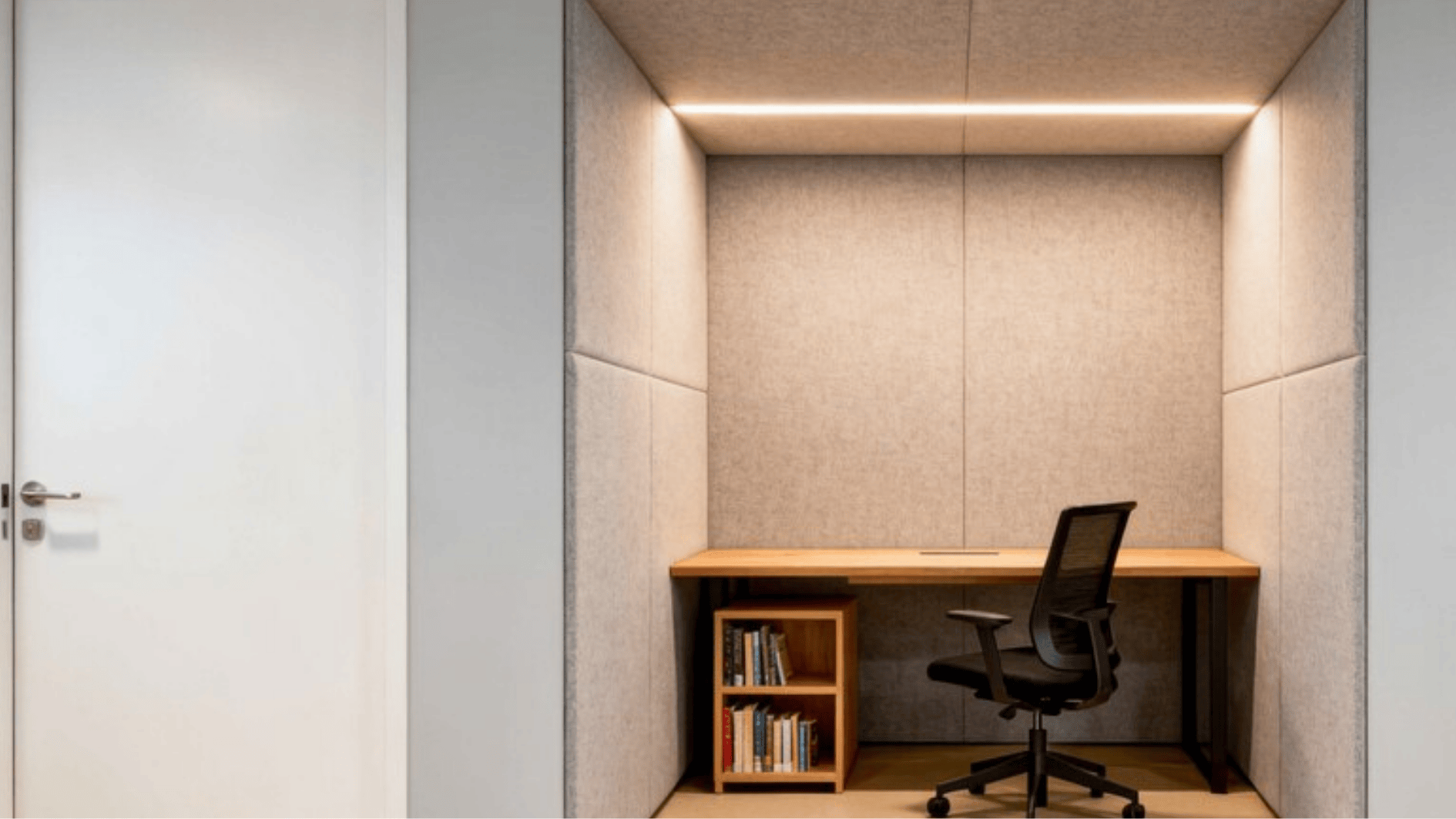 private acoustic focus booth with desk, chair, shelving, and soft lighting designed for quiet individual work