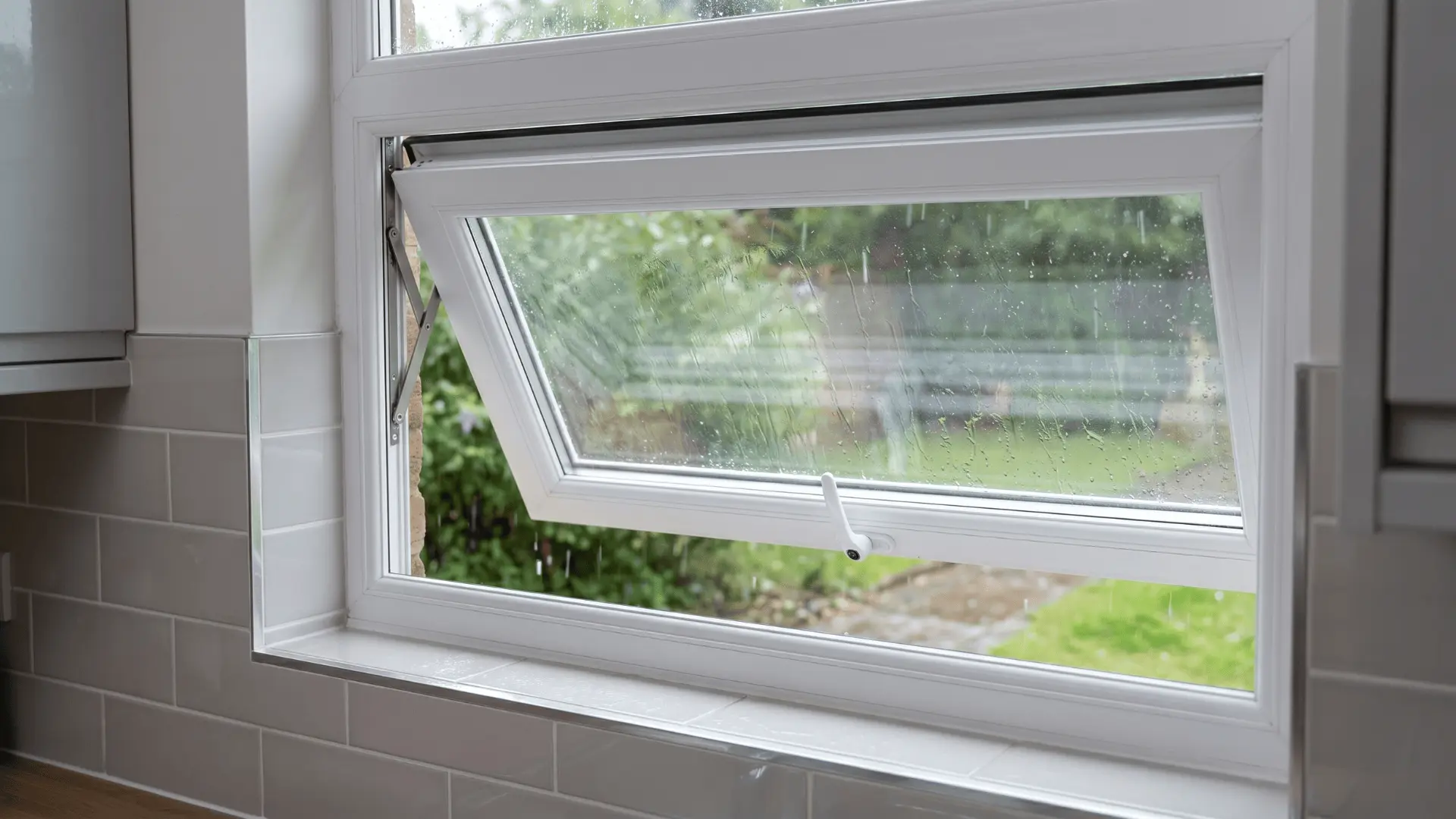 PVC awning window open outward from bottom during light rain