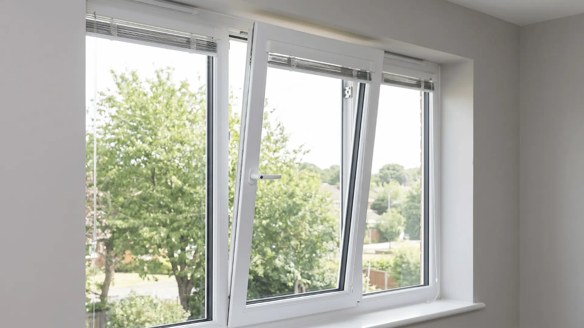 PVC tilt-and-turn window tilted inward at top for airflow