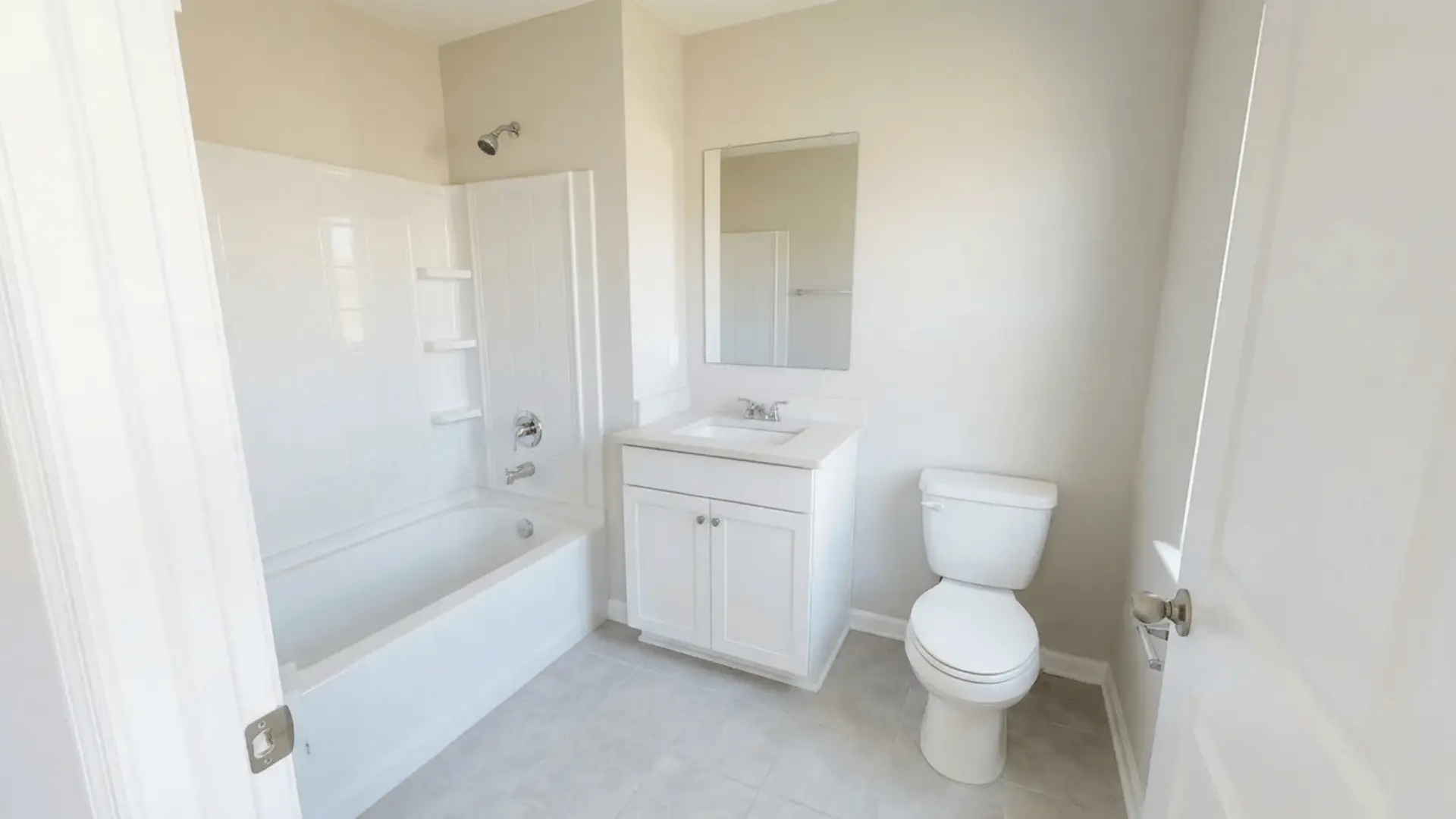 Small 5x8 residential bathroom with tub on left wall, vanity centered, and toilet on right wall.