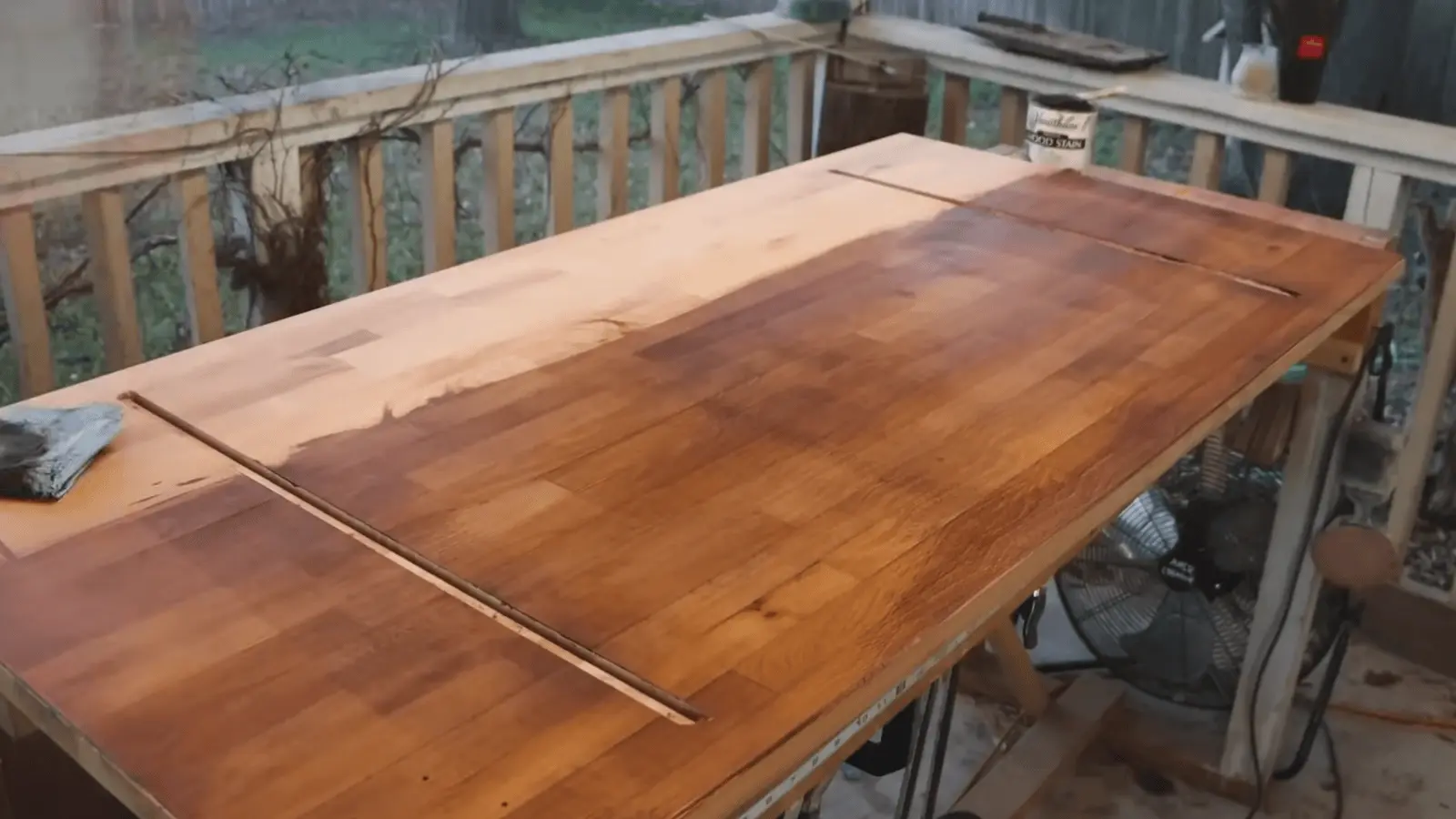 Testing stain application on underside of wooden table