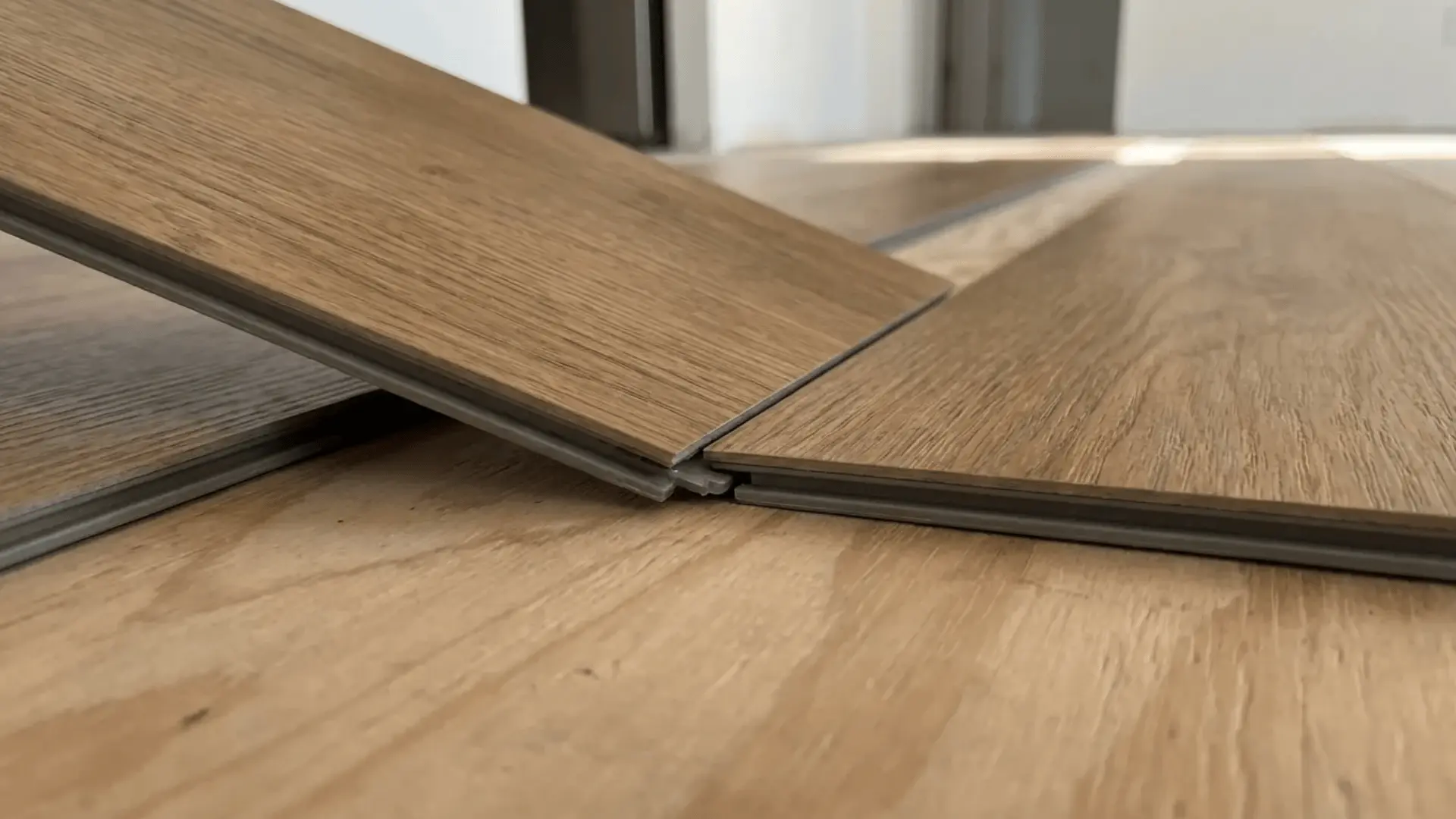 Two LVT planks connecting with a click-lock edge system during floor installation.