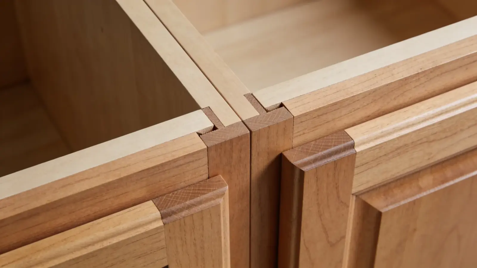 Wood cabinet corner showing exposed joinery and wood joints