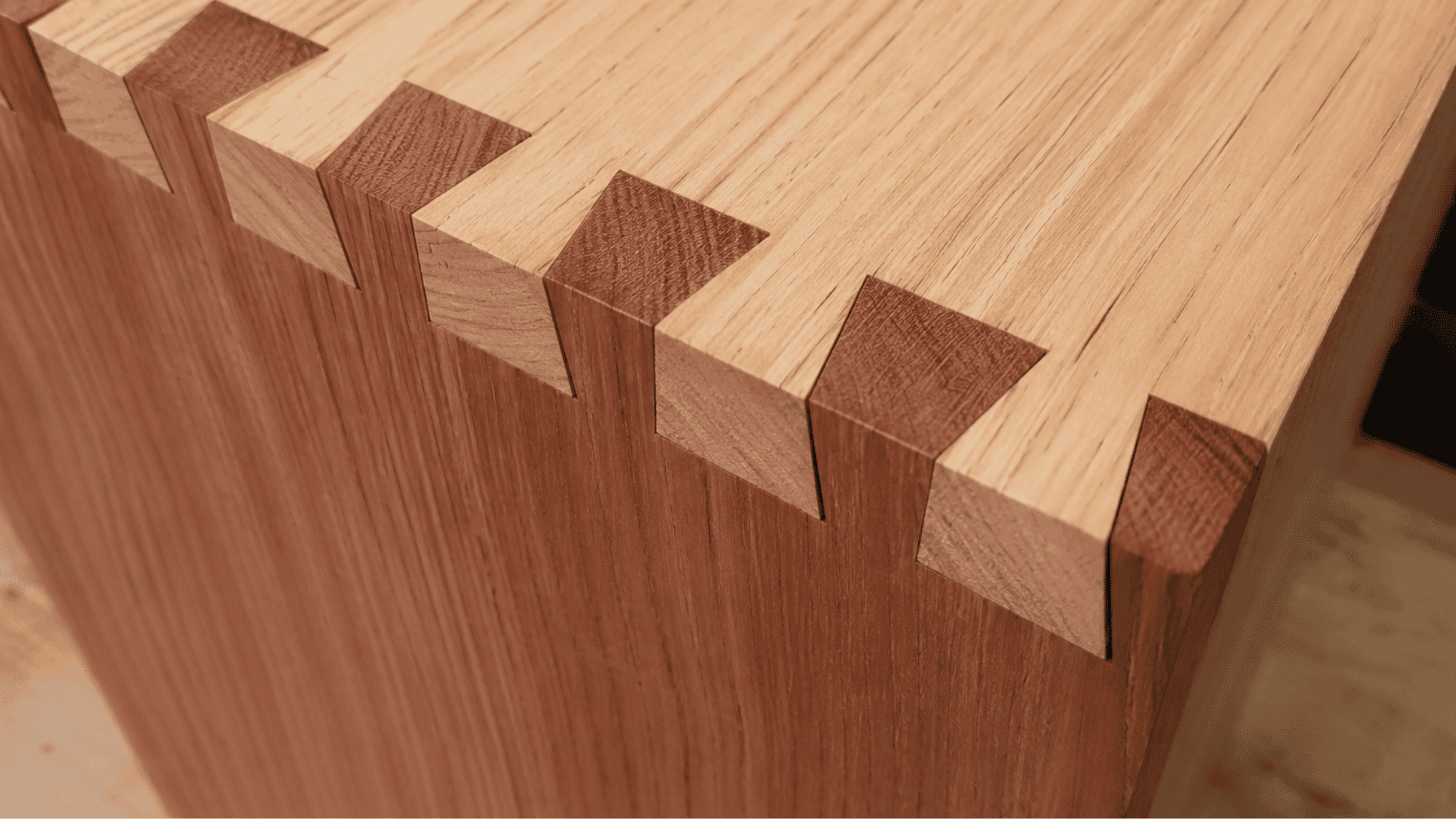 Close-up realistic dovetail joint with interlocking walnut wood pins and tails on a dark wooden surface.