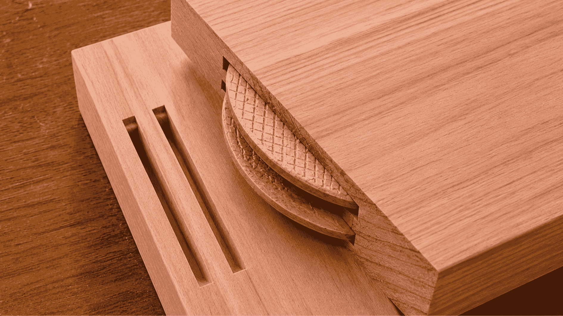 Realistic biscuit joint with walnut wood boards and visible oval biscuit slot on a white background.