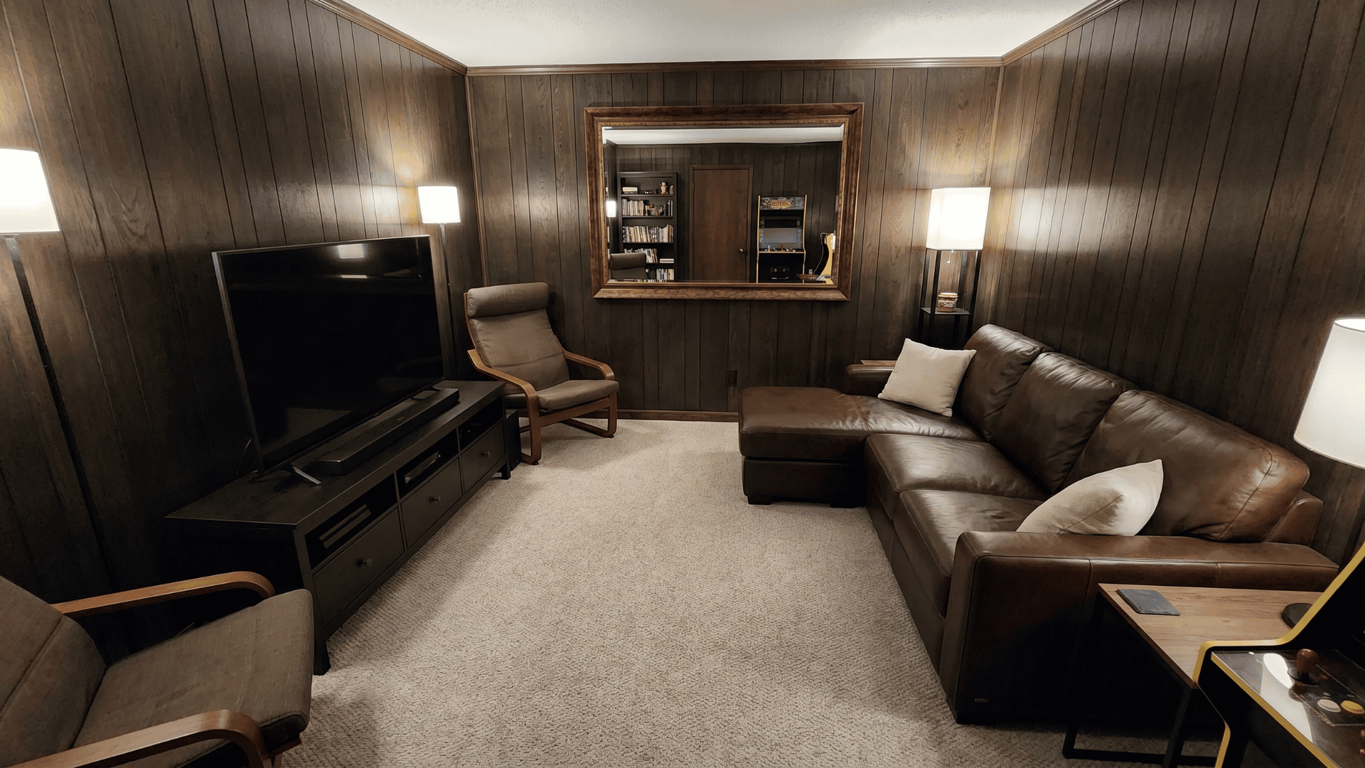Small man cave Small man cave with furniture along walls and clear walking paths vertical storage and floating shelves keeping floors clear