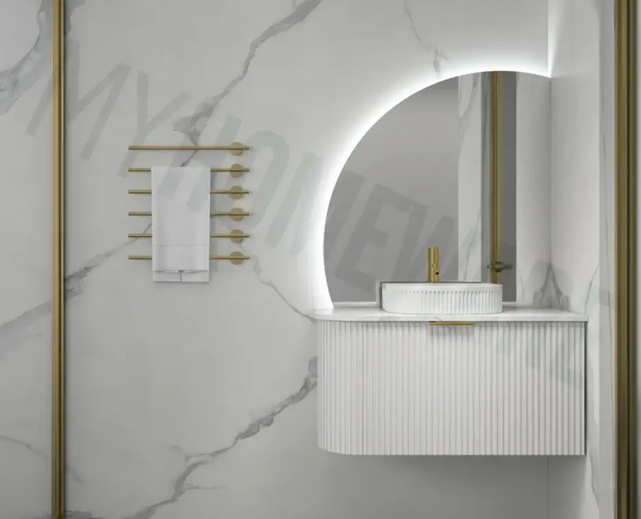 Modern bathroom with white fluted vanity and gold faucet on marble wall