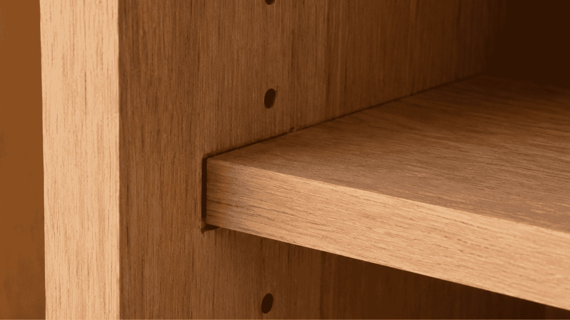 dado joint shelf fitted into a wooden cabinet side panel with visible groove support.