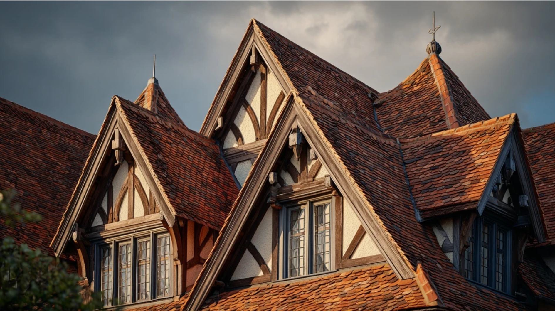 dramatically steep Tudor Revival roofline with multiple gables and decorative half-timbering in the gable triangles
