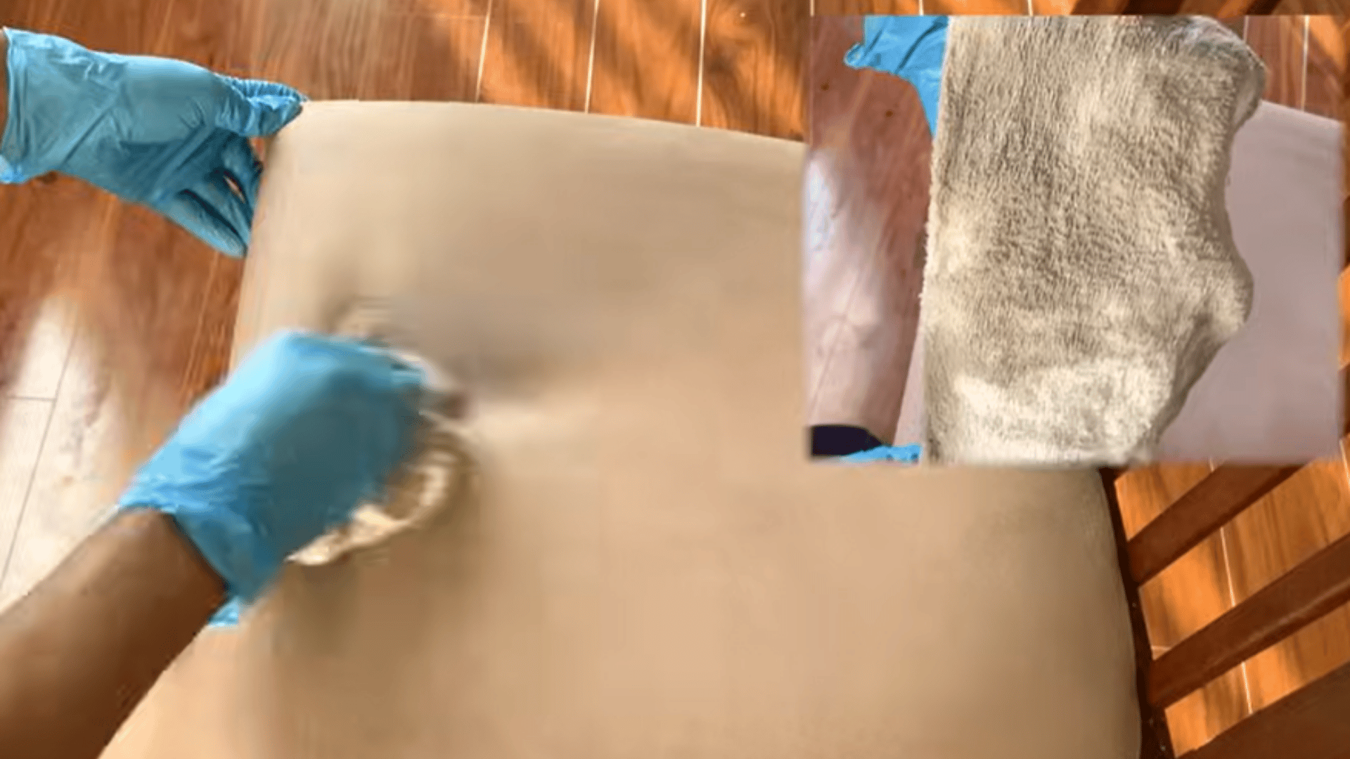 Gloved hands wiping upholstered chair seat with a cloth, lifting remaining dirt as shown by the soiled cloth inset.
