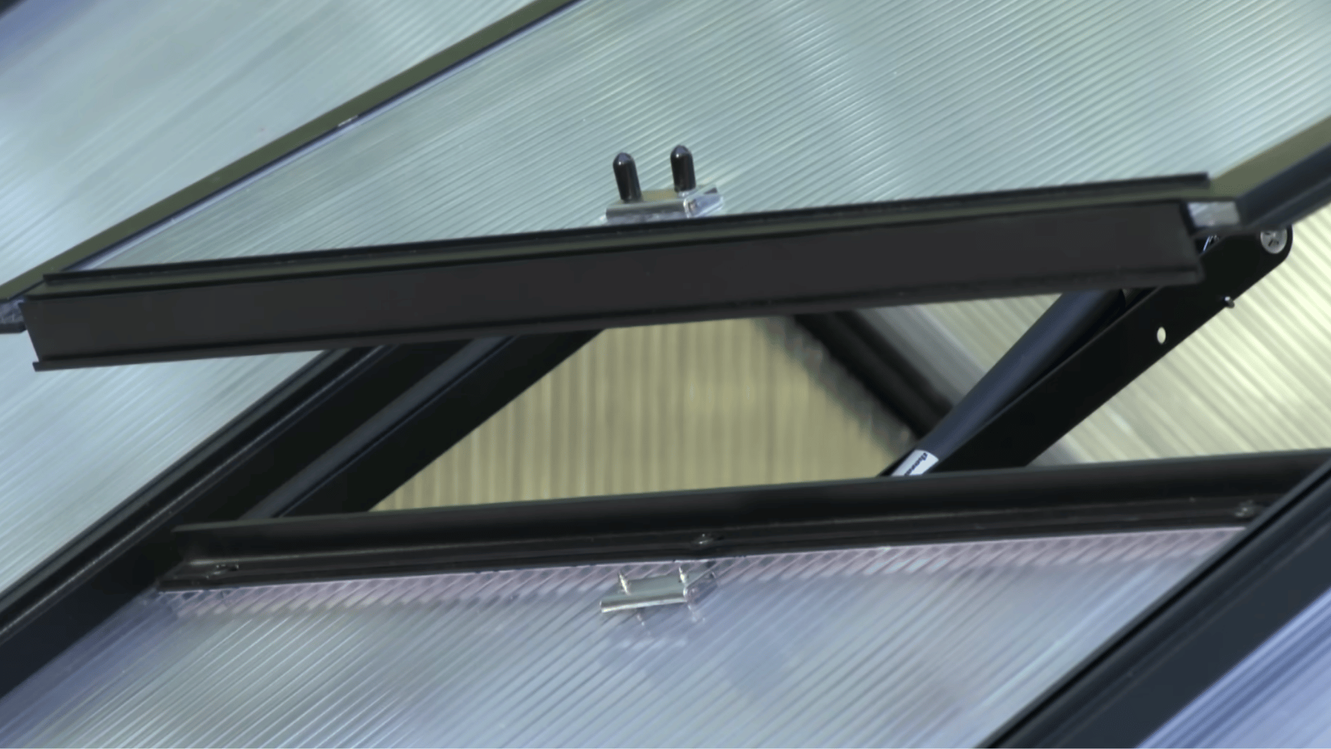 Greenhouse door and roof vent installed for proper airflow and temperature control inside the structure.