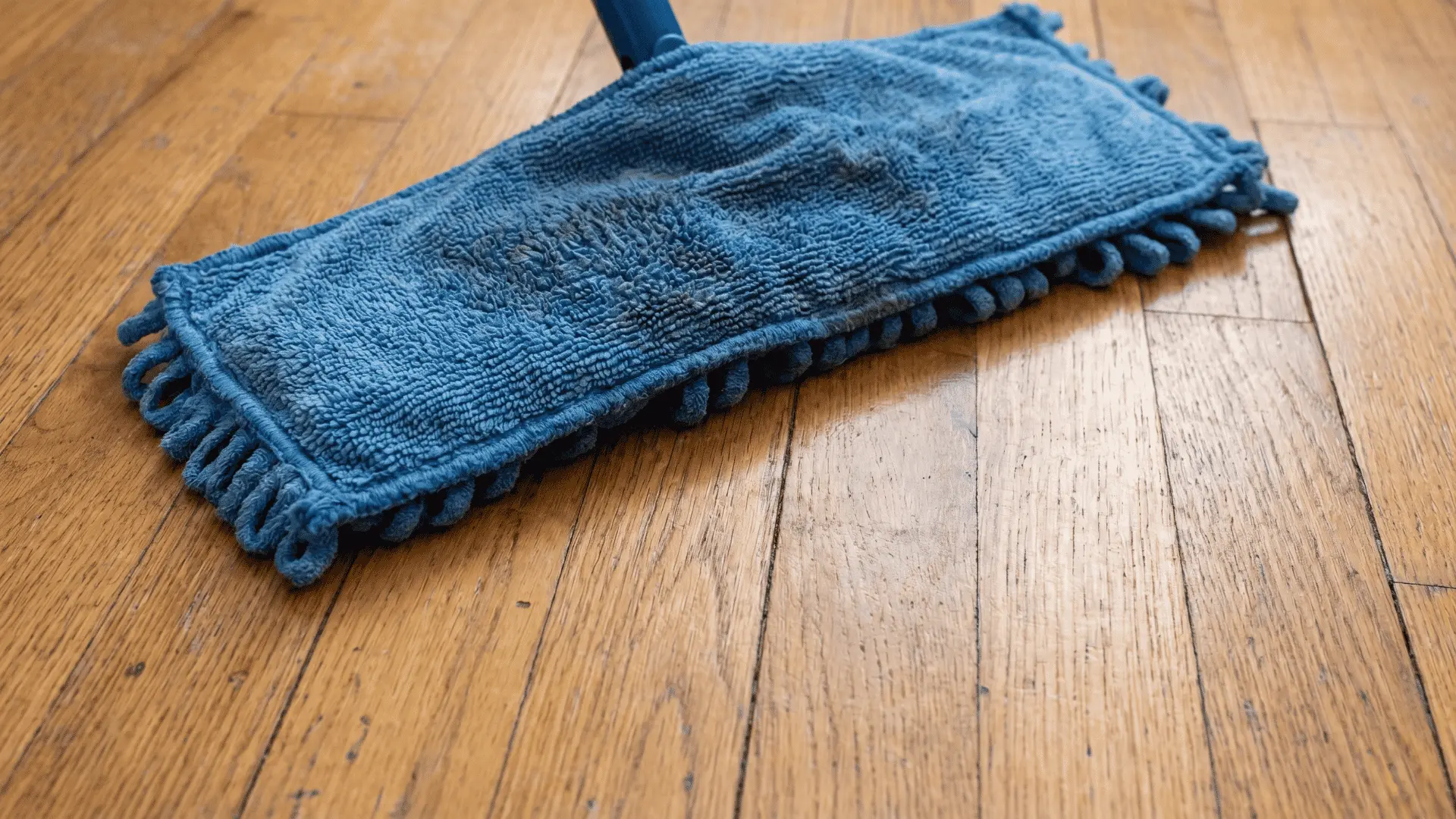 Slightly damp microfiber mop on hardwood floor with no excess liquid