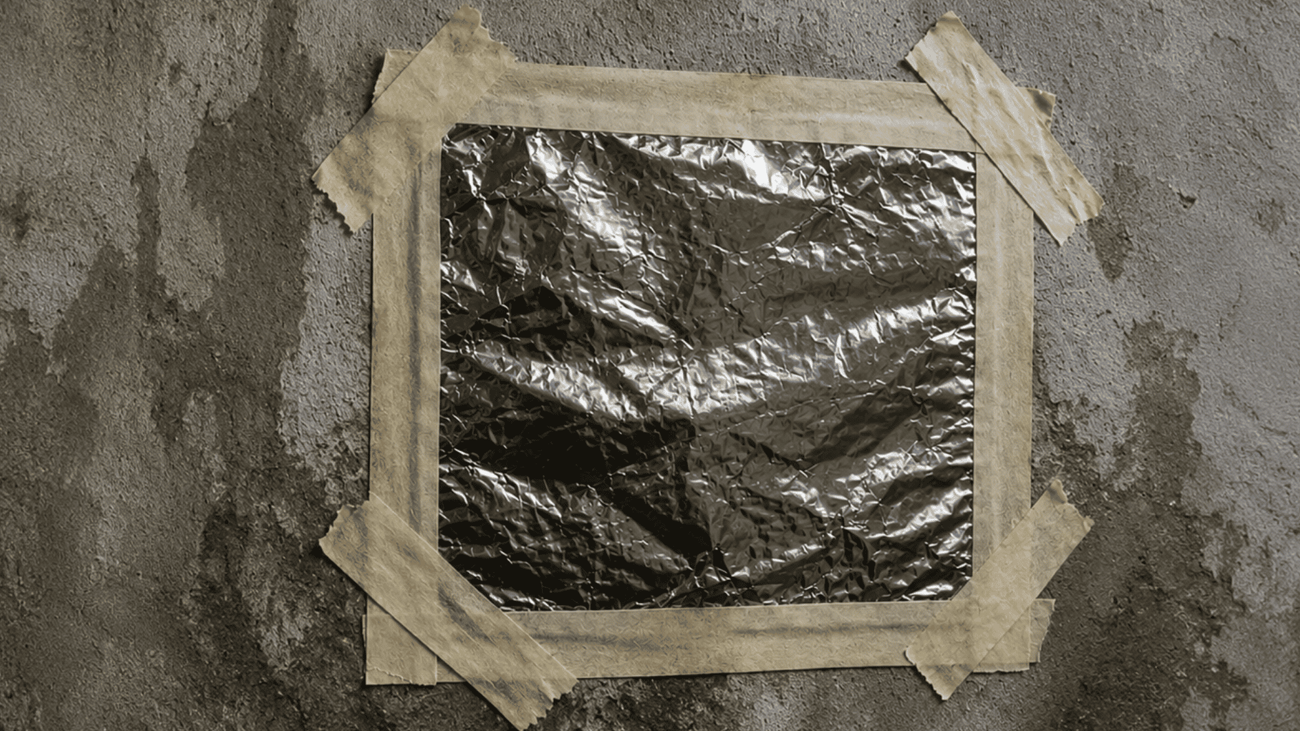 taped foil on a damaged wall