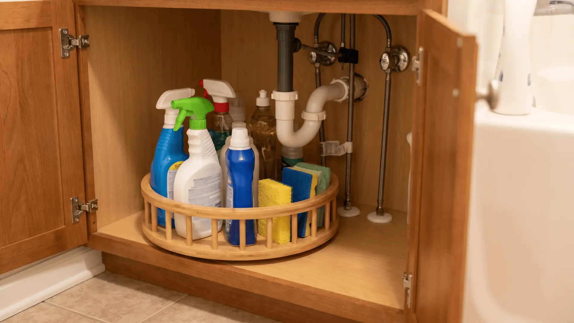 Turntable organizer under sink with neatly arranged bottles