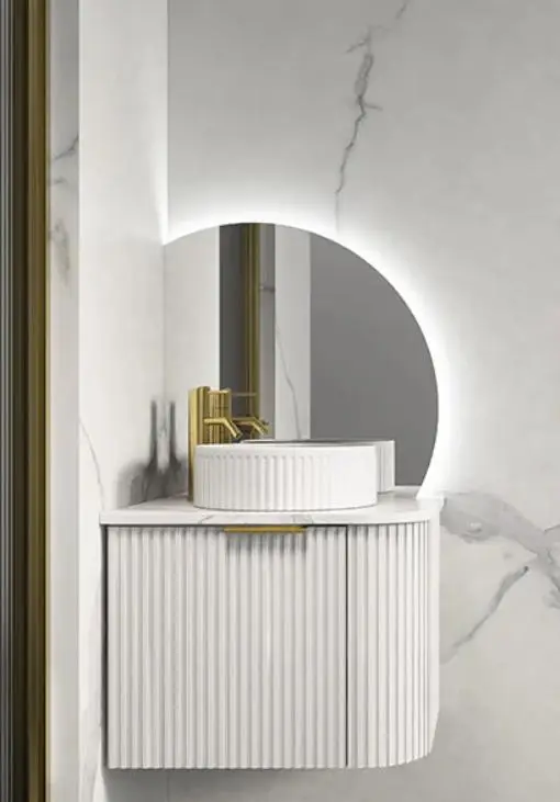 Round backlit mirror and ribbed countertop basin in modern bathroom with marble walls