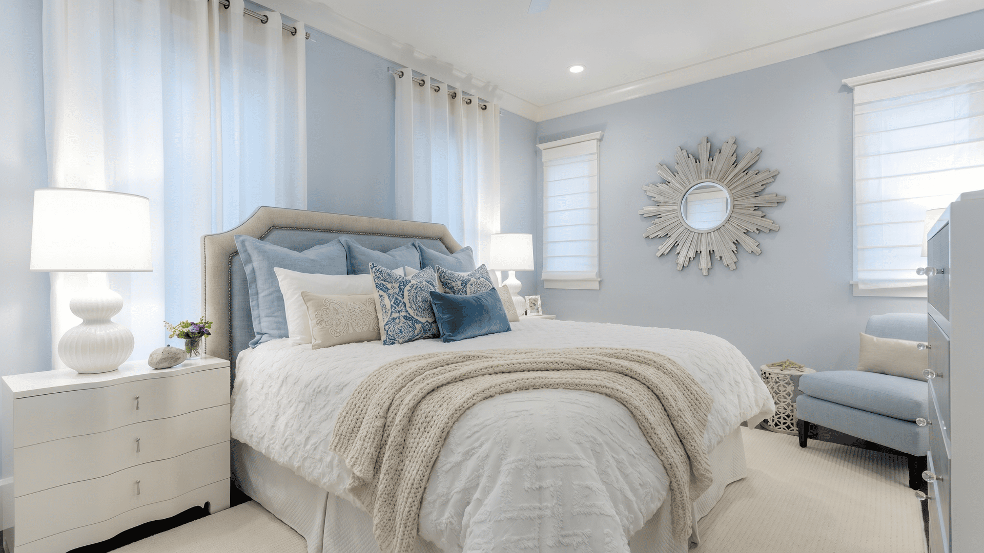Bedroom with Misty SW 6232 walls, white bedding, blue-gray pillows, and natural wood accents.