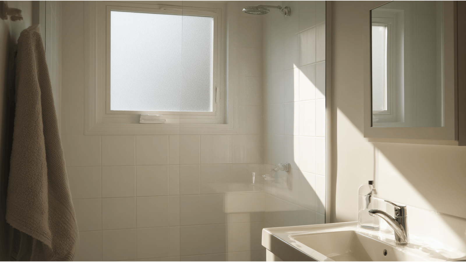 Small frosted bathroom casement window with privacy, ventilation, sunlight, and modern bathroom interior.