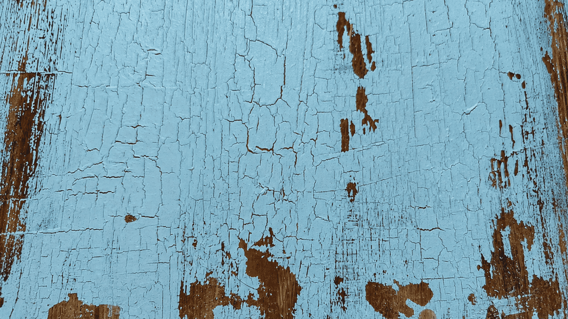 acrylic paint failing to adhere properly to a wooden surface, leaving crack