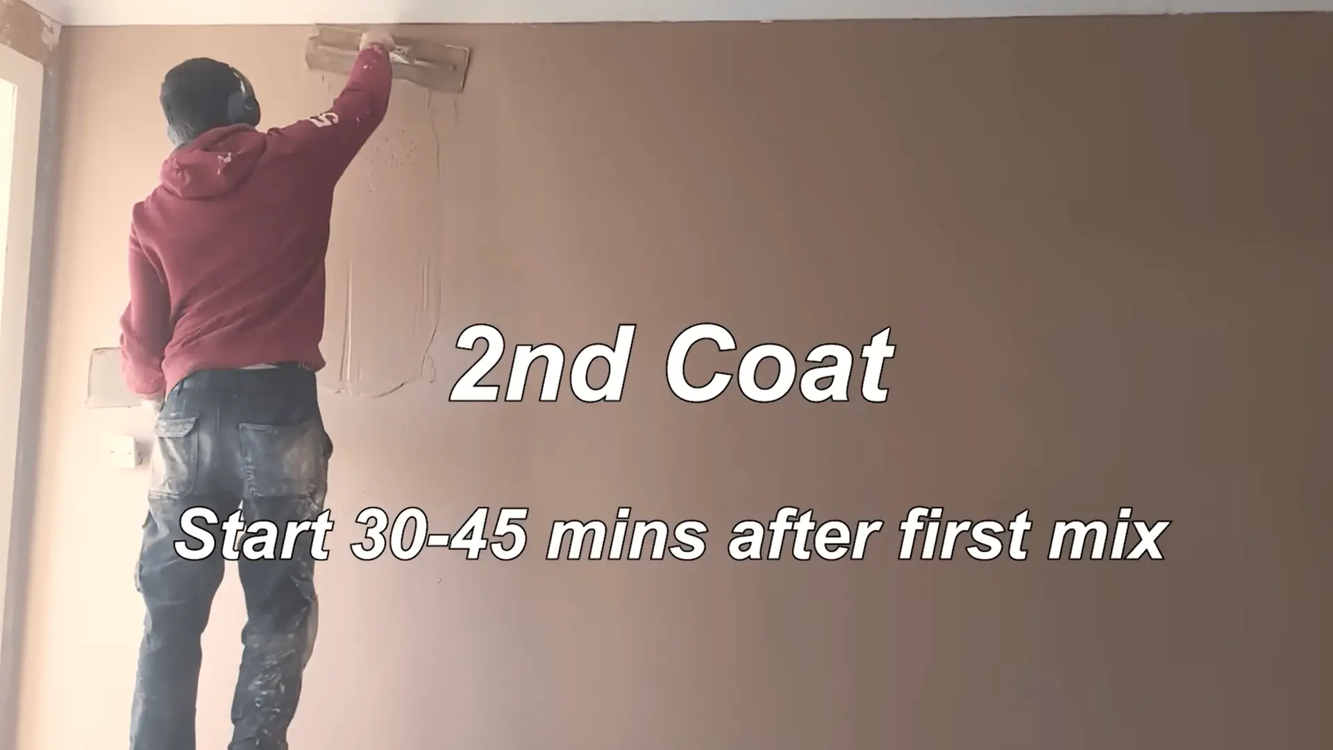 Applying the second coat of plaster, starting 30-45 minutes after the first mix, ensuring a smoother finish with a trowel