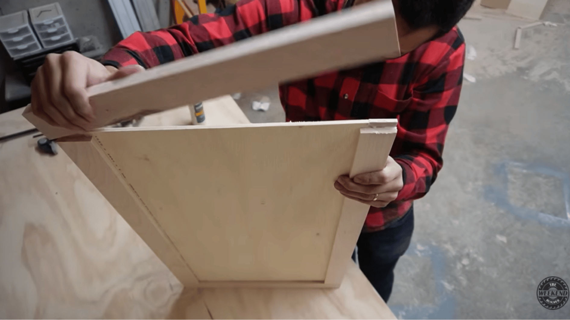 assembling a shaker-style cabinet door frame around a plywood center panel for custom diy kitchen cabinets.