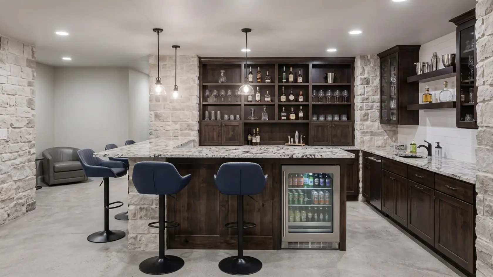 Basement wet bar with cabinets, sink, small fridge, countertop, and stools along one wall (1)