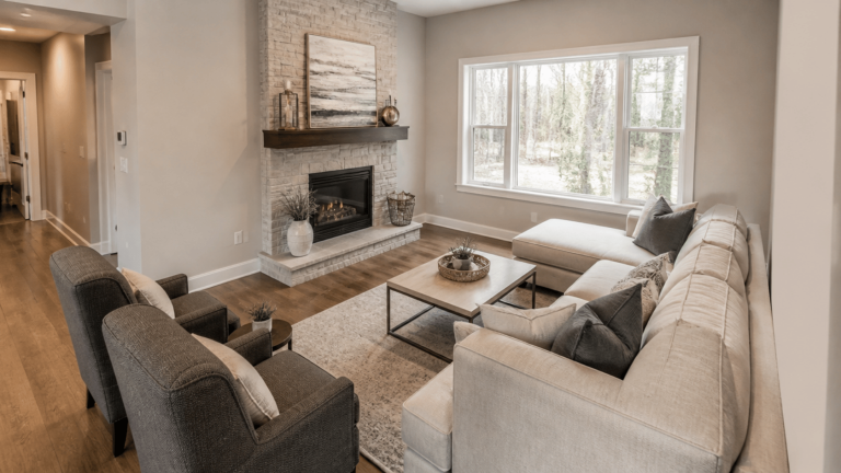Chairs and sectional angled toward a corner with a fireplace and window in a living room
