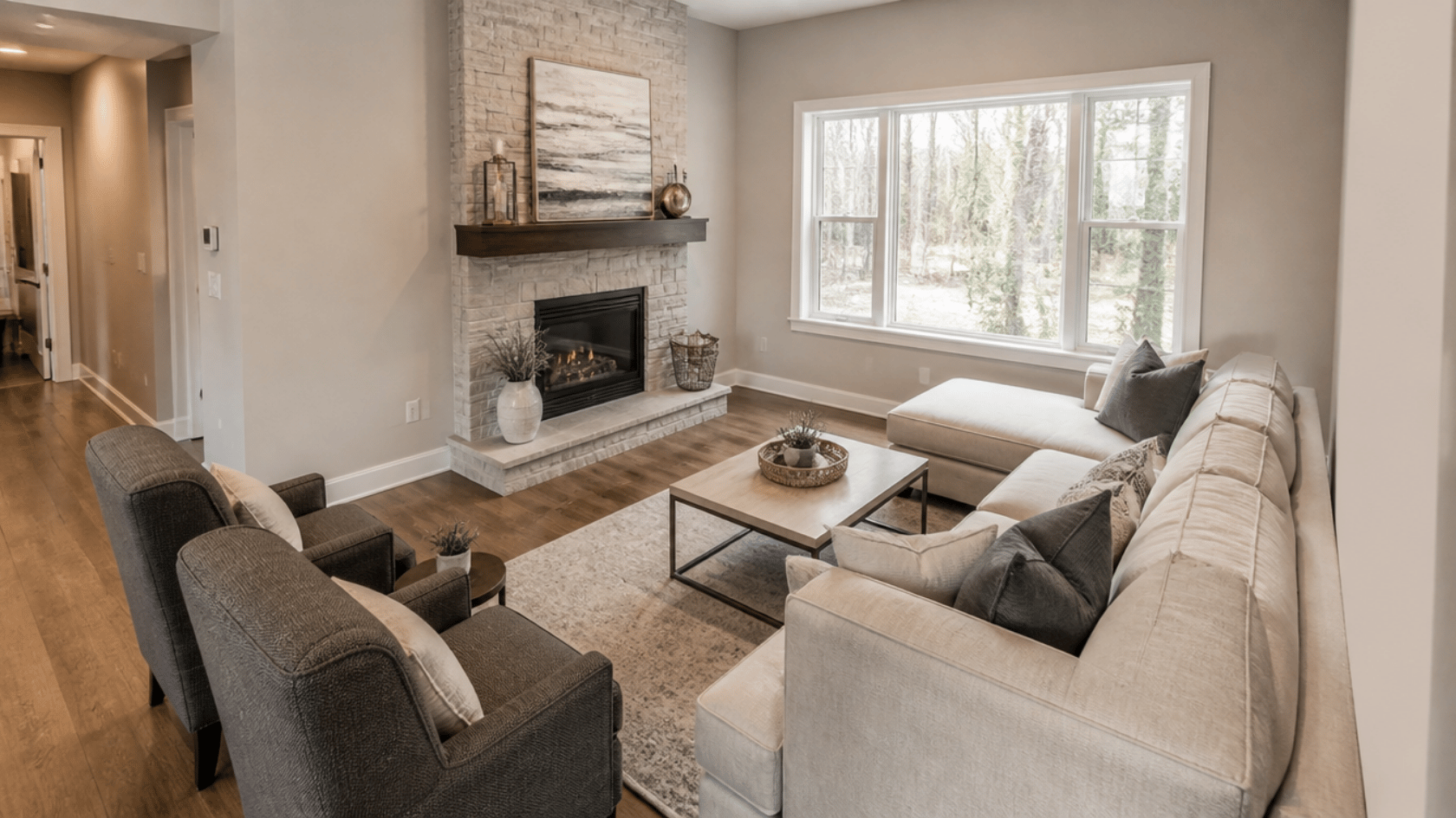 Chairs and sectional angled toward a corner with a fireplace and window in a living room