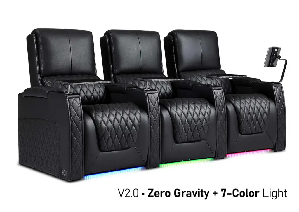 Three black leather recliners with quilted design and colorful LED base lighting in modern setting