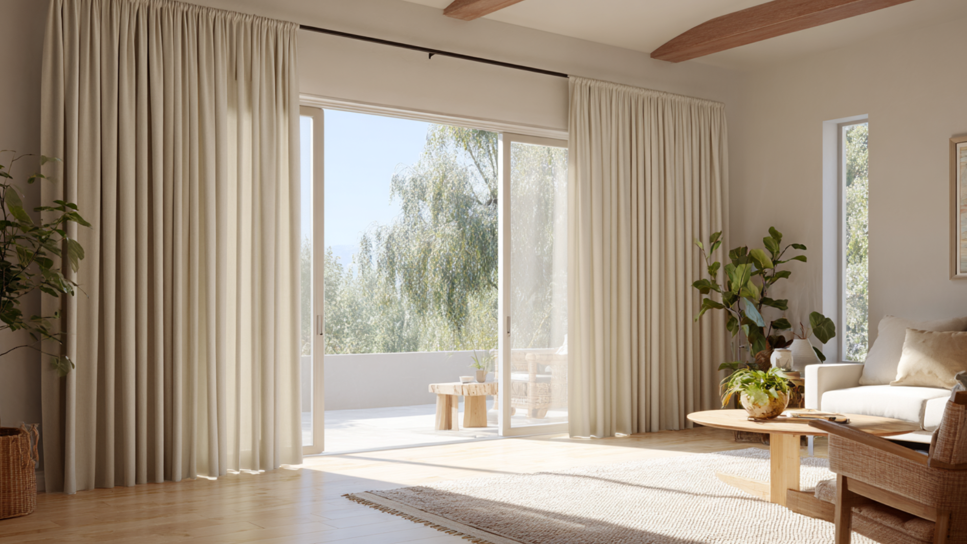 floor to ceiling ivory curtains frame large sliding glass doors in a bright living room with natural light and plants
