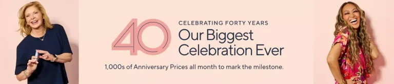 Two women smiling against a pink background, wearing colorful clothing, celebrating an event anniversary