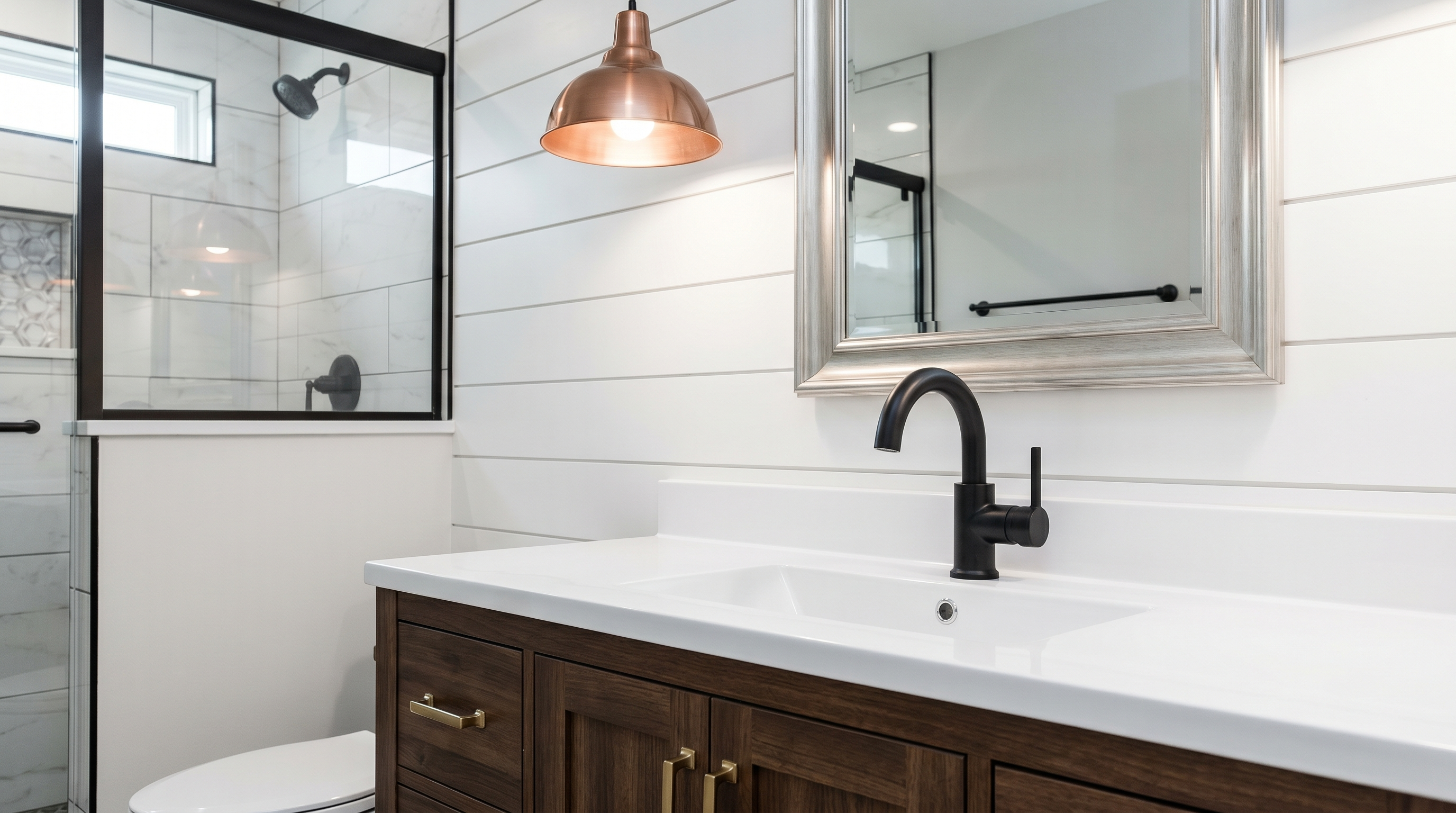 Black, brass, copper, and silver faucets, pulls, and lighting in a stylish modern farmhouse bathroom.