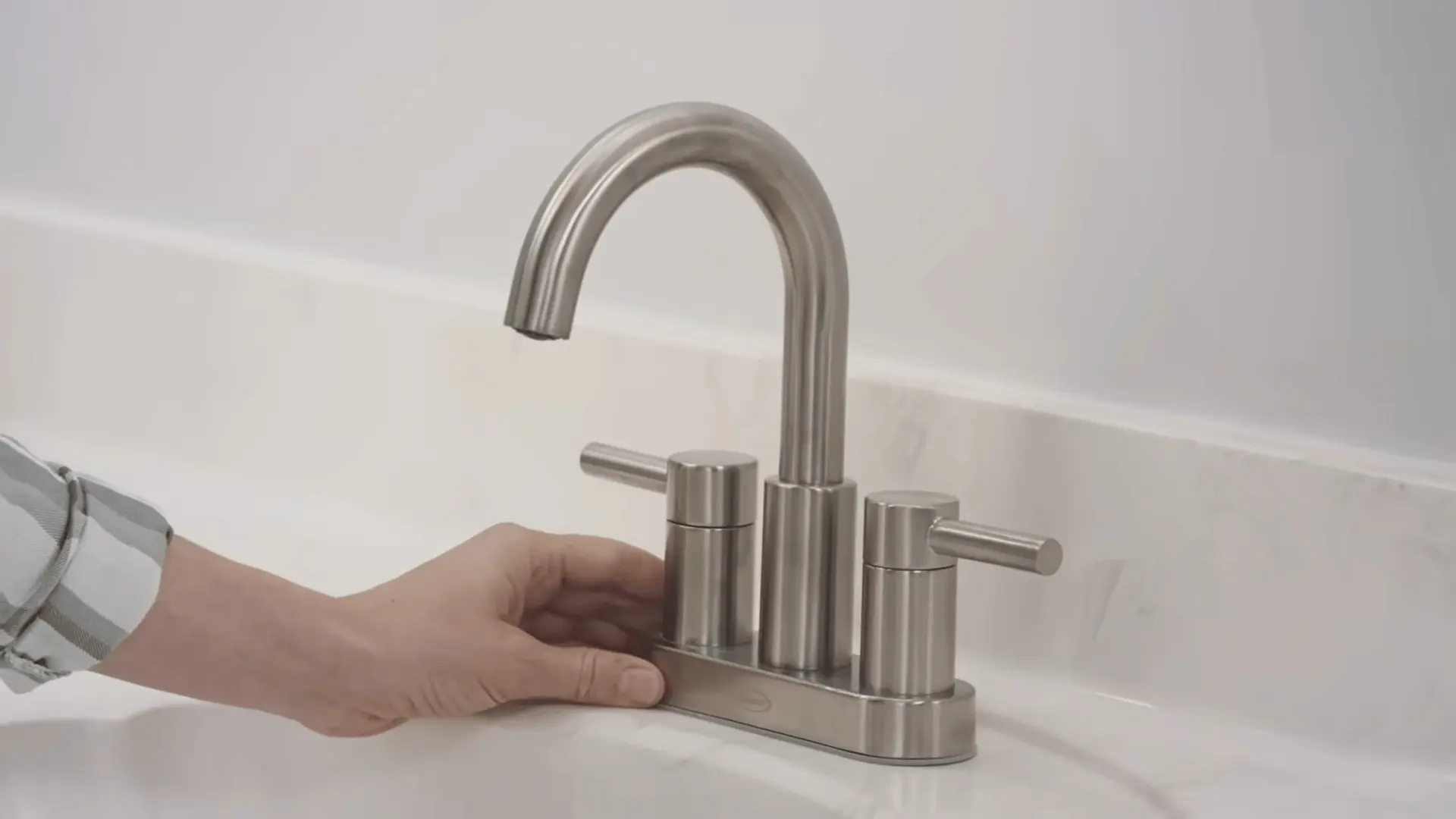 Installing a new faucet on the bathroom vanity after painting and reassembly