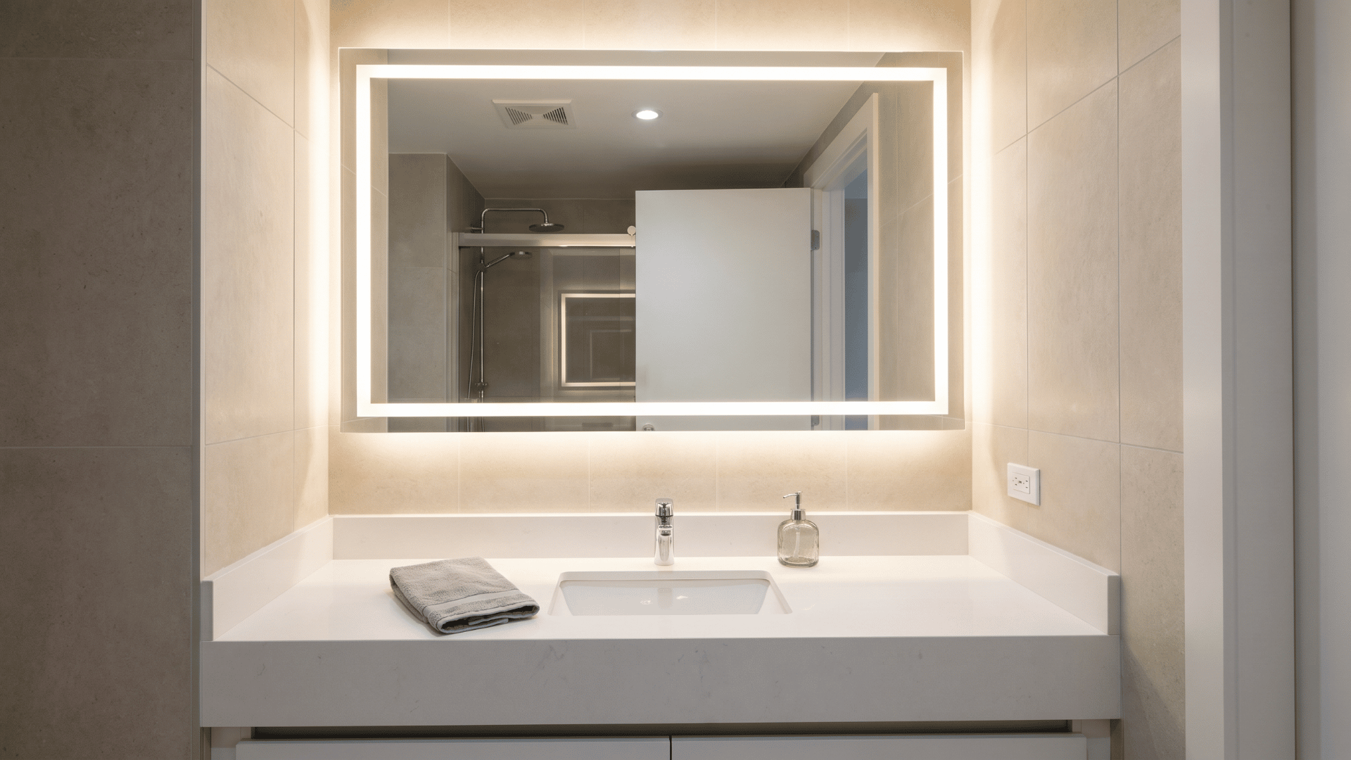 LED bathroom mirror above a clean vanity