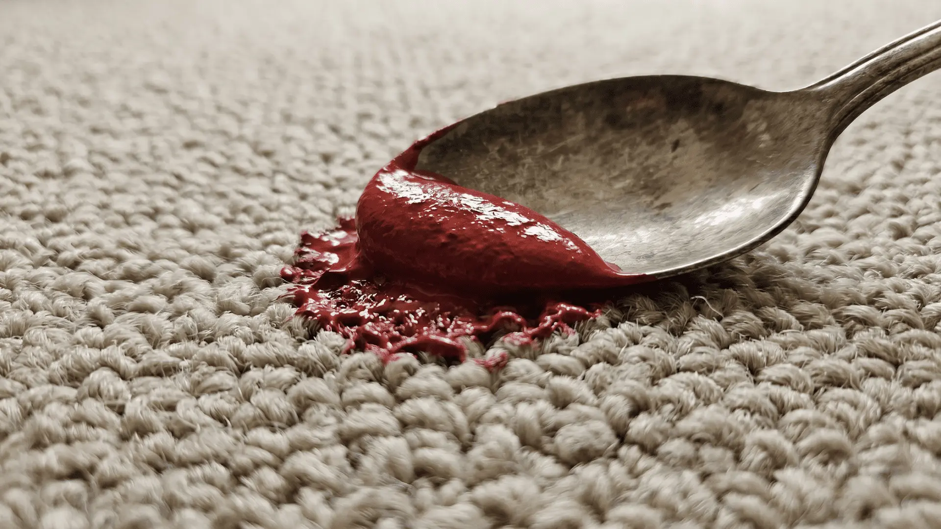 Metal spoon edge lifting wet paint from carpet fibers